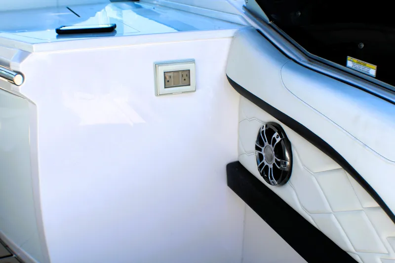 Sea M.a.j.i.c. Yacht Photos Pics 2022 Regal 33 OBX boat interior with speaker and power outlet.