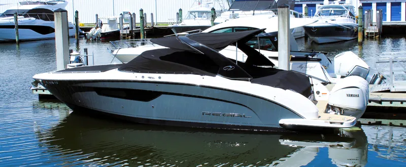 Sea M.a.j.i.c. Yacht Photos Pics 2022 Regal 33 OBX boat docked in marina, featuring sleek design and Yamaha engines.