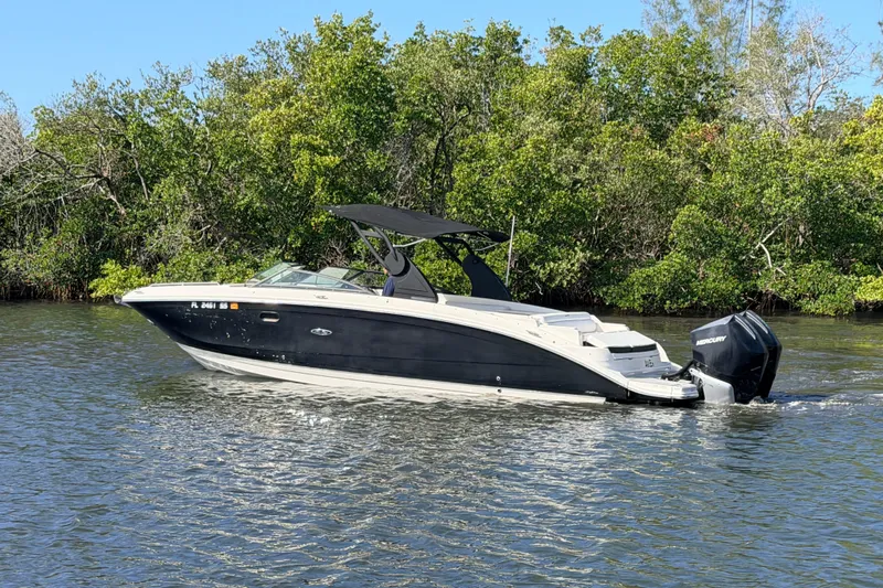  Yacht Photos Pics 2020 Sea Ray SDX 290 Outboard boat cruising on a calm river near lush greenery.