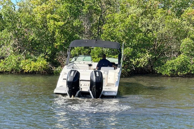  Yacht Photos Pics 2020 Sea Ray SDX 290 Outboard navigating through lush green waters.