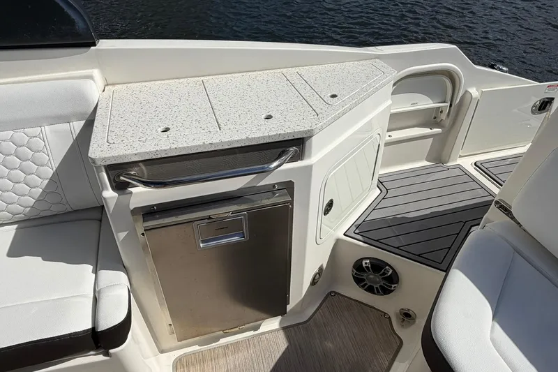 Yacht Photos Pics 2020 Sea Ray SDX 290 Outboard boat interior with seating and kitchenette area.