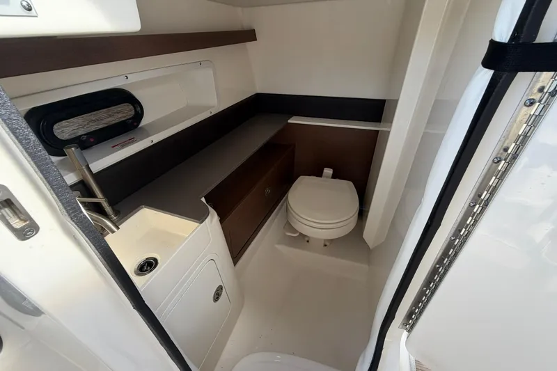  Yacht Photos Pics 2020 Sea Ray SDX 290 Outboard boat interior with compact bathroom amenities.