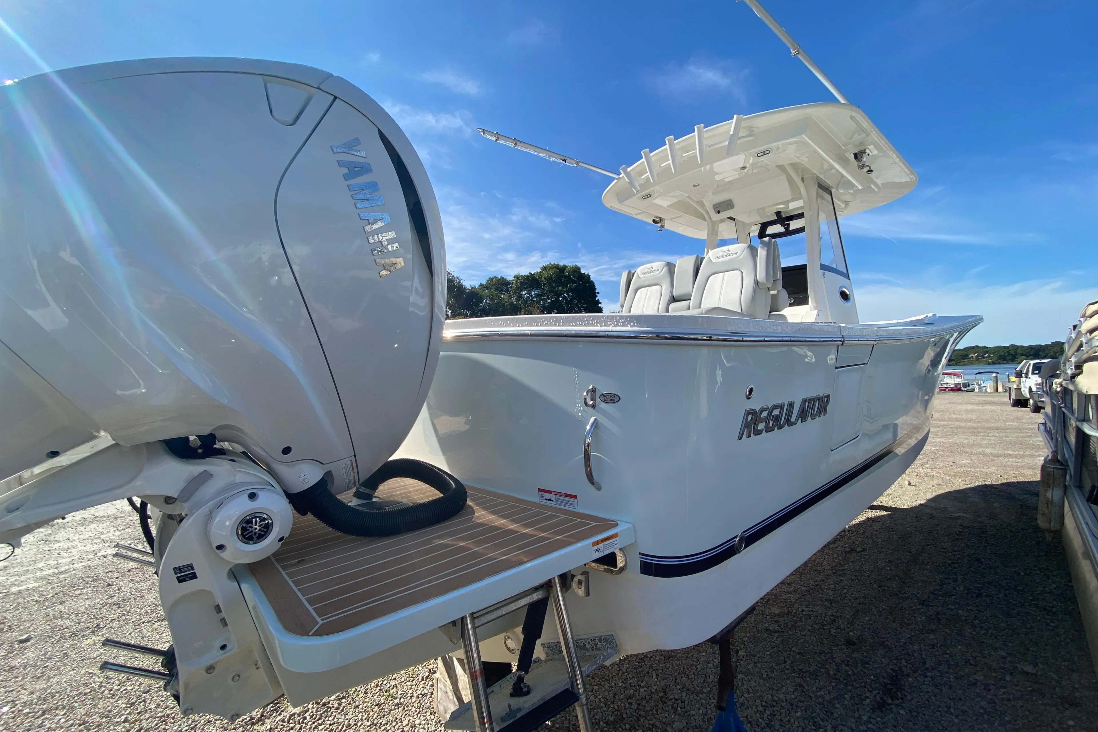 2022 Regulator 31 boat with Yamaha engine, docked under clear blue sky.