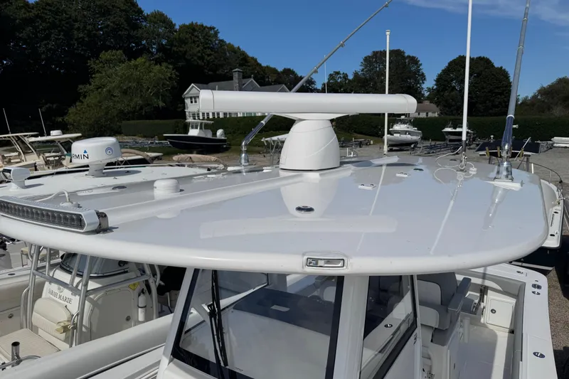  Yacht Photos Pics 2022 Regulator 31 boat with advanced navigation equipment, docked in a marina.