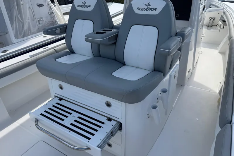 Yacht Photos Pics 2022 Regulator 31 boat seating with armrests and storage compartments.