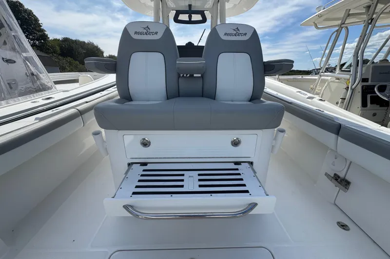  Yacht Photos Pics 2022 Regulator 31 boat interior with dual seats and storage compartment.