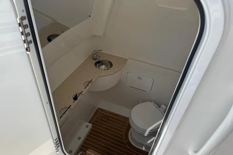  Yacht Photos Pics 2022 Regulator 31 boat interior bathroom with sink and toilet.