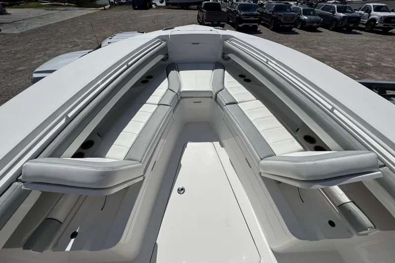  Yacht Photos Pics 2022 Regulator 31 boat interior with white cushioned seating and cup holders.