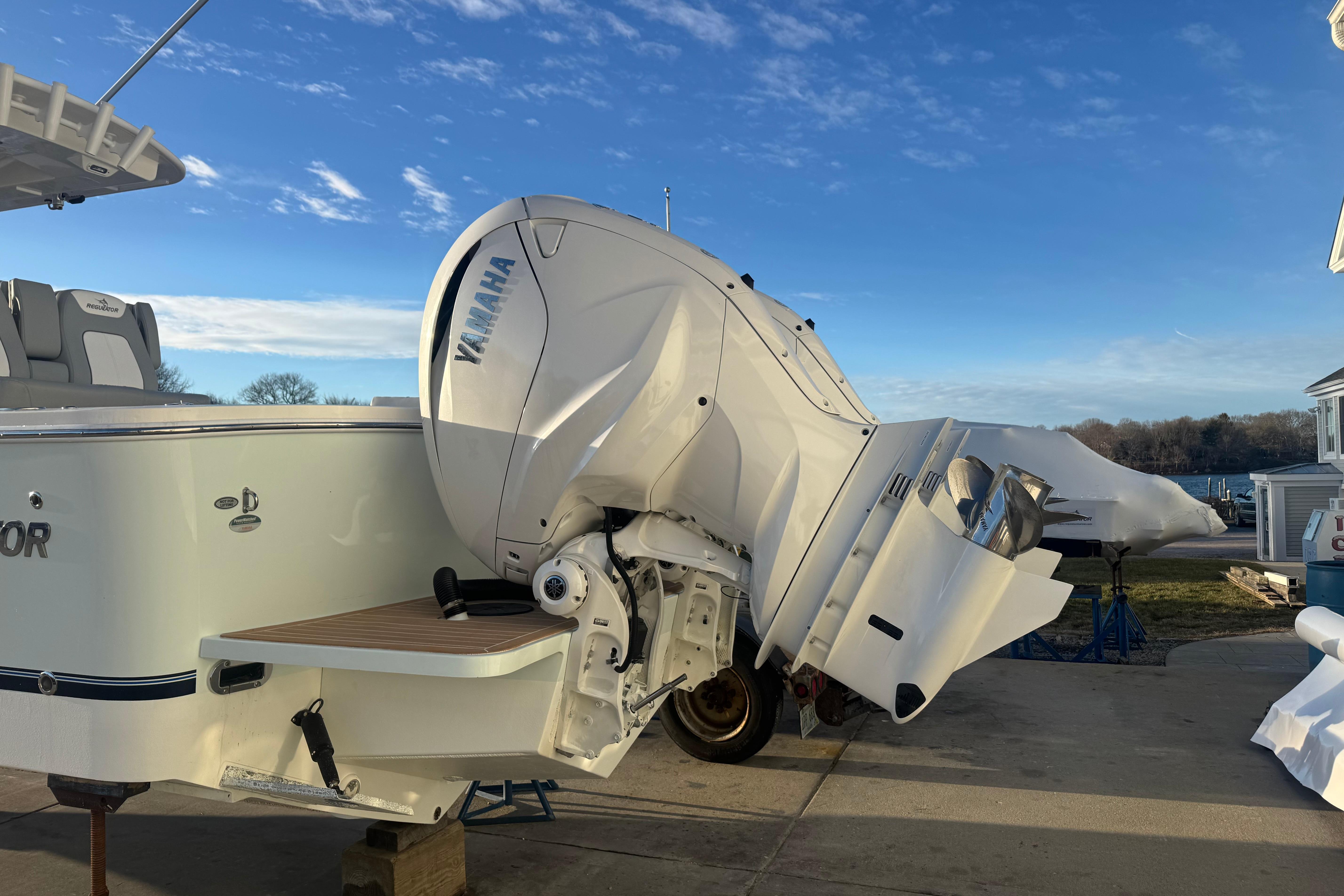 2022 Regulator 31 boat with Yamaha outboard motor, docked under a clear blue sky.