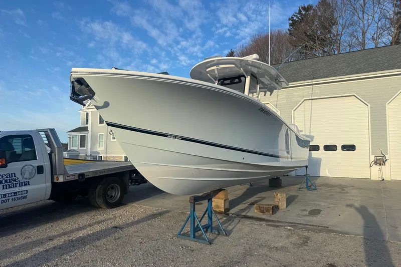  Yacht Photos Pics 2022 Regulator 31 boat on stands outside a marina garage.