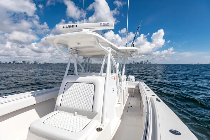  Yacht Photos Pics 2020 SeaHunter 33 Tournament boat on open water with city skyline in background.
