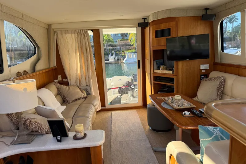 Reelin N Rockin Yacht Photos Pics Luxurious interior of a 2003 Silverton 38 Convertible yacht with cozy seating and elegant decor.