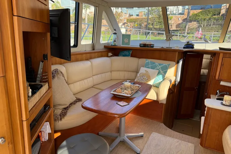 Reelin N Rockin Yacht Photos Pics Luxurious interior of a 2003 Silverton 38 Convertible yacht with cozy seating and decor.