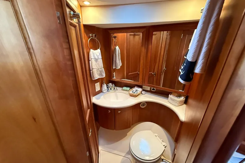 Reelin N Rockin Yacht Photos Pics Luxurious bathroom in 2003 Silverton 38 Convertible yacht with wood accents and modern fixtures.