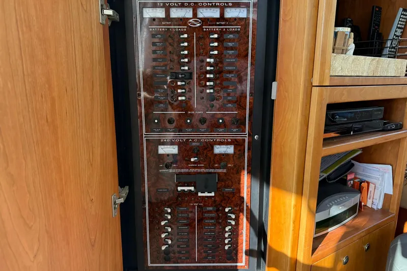 Reelin N Rockin Yacht Photos Pics Electrical control panel on a 2003 Silverton 38 Convertible boat, featuring 12V DC and 240V AC controls.