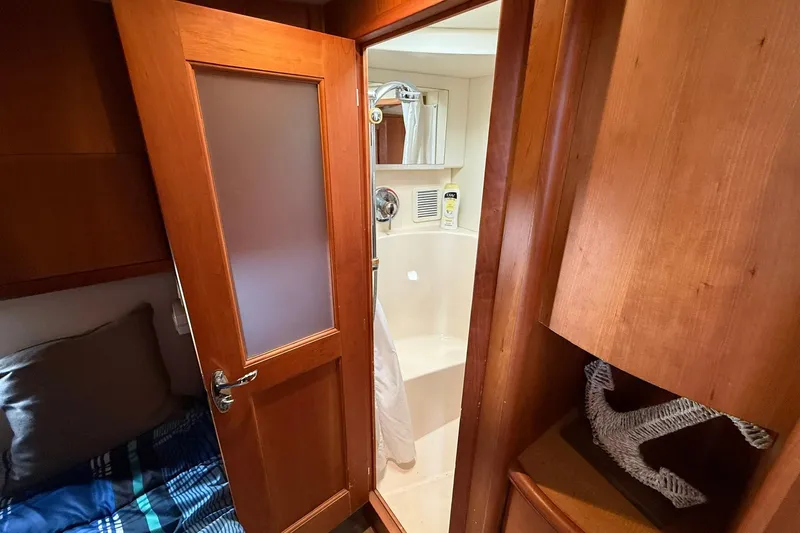 Reelin N Rockin Yacht Photos Pics 2003 Silverton 38 Convertible yacht interior with wooden door and compact bathroom.