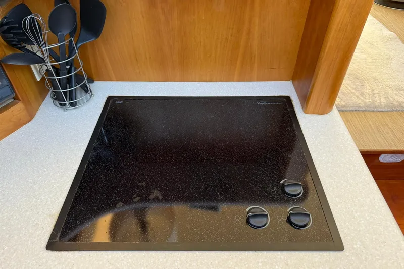 Reelin N Rockin Yacht Photos Pics Stovetop in 2003 Silverton 38 Convertible yacht kitchen with utensils.