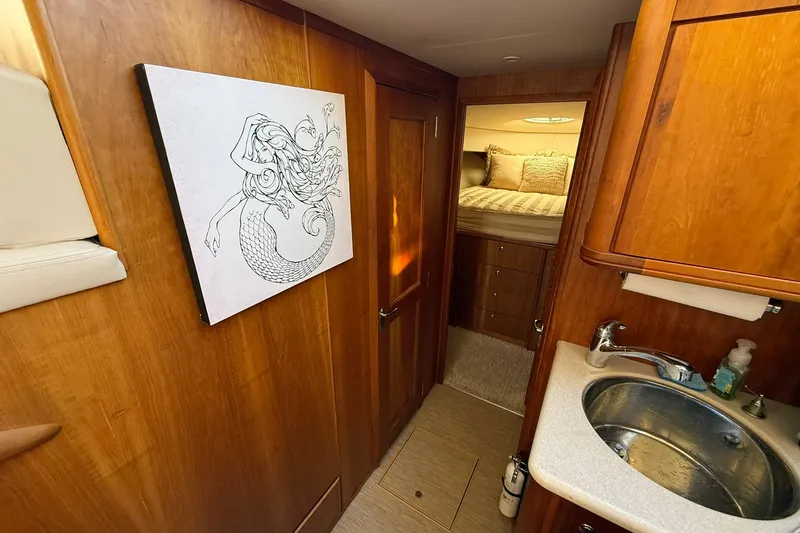 Reelin N Rockin Yacht Photos Pics Interior of 2003 Silverton 38 Convertible yacht with mermaid artwork and cozy cabin.