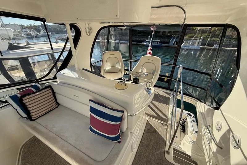 Reelin N Rockin Yacht Photos Pics Interior of a 2003 Silverton 38 Convertible yacht with seating and helm.
