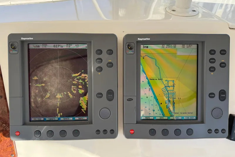 Reelin N Rockin Yacht Photos Pics Dual Raymarine navigation displays on 2003 Silverton 38 Convertible boat, showing radar and map.