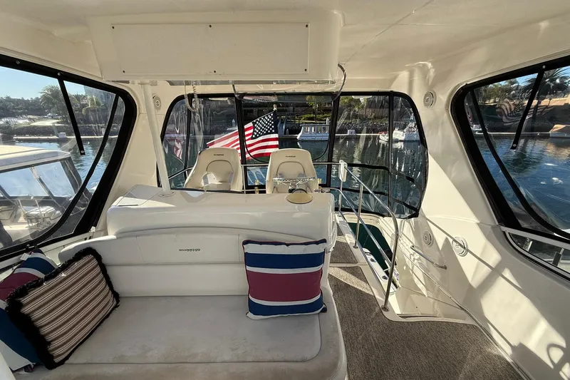 Reelin N Rockin Yacht Photos Pics Interior of 2003 Silverton 38 Convertible yacht with seating and American flag.
