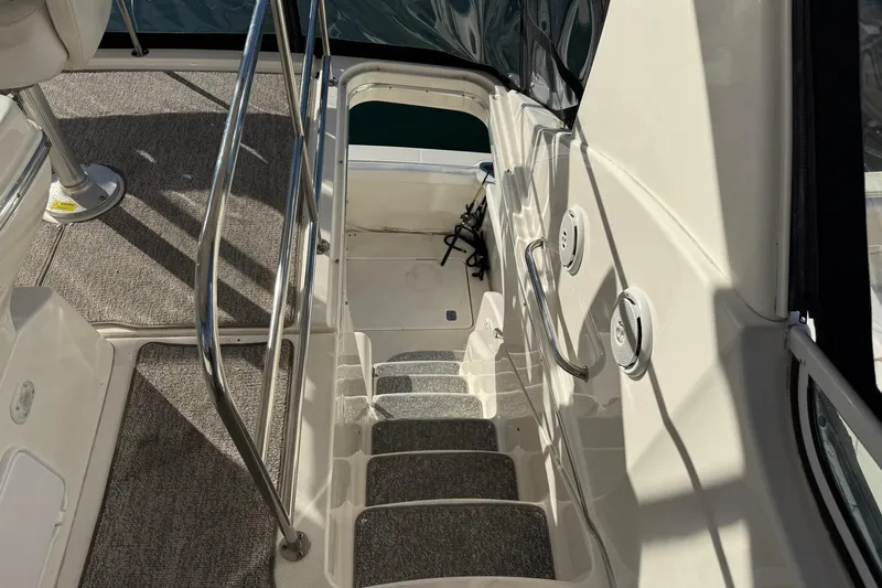 Reelin N Rockin Yacht Photos Pics 2003 Silverton 38 Convertible boat interior stairs with carpet and railing.