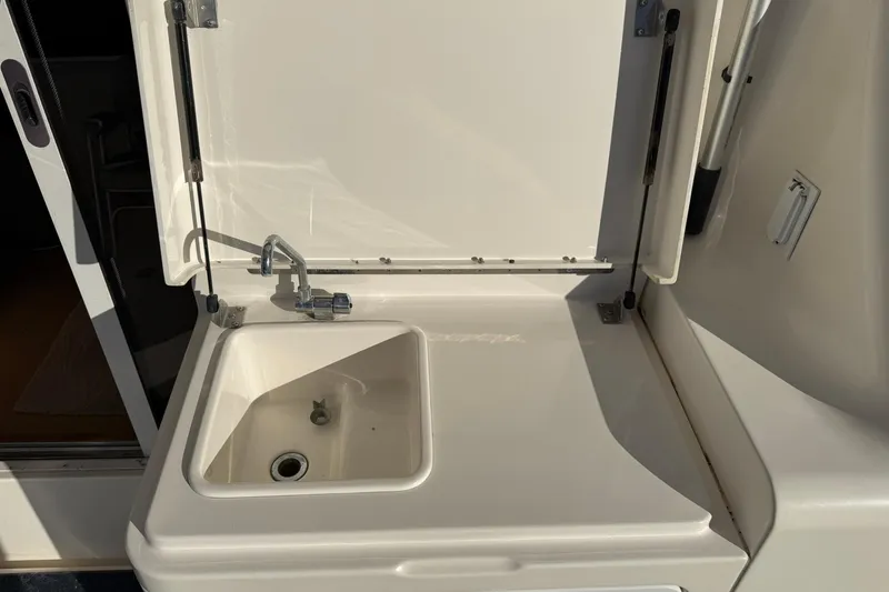Reelin N Rockin Yacht Photos Pics 2003 Silverton 38 Convertible yacht sink with closed lid and faucet.