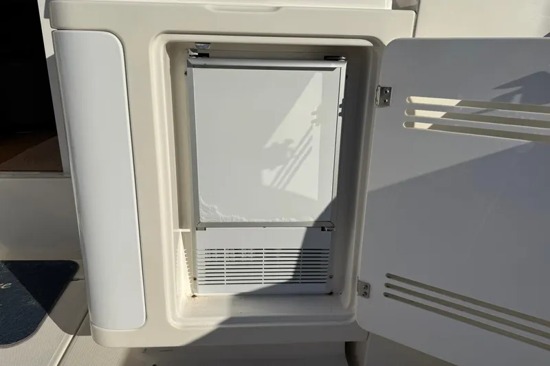 Reelin N Rockin Yacht Photos Pics 2003 Silverton 38 Convertible boat refrigerator with open door, showcasing interior.