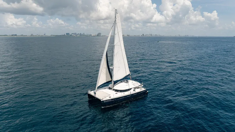 Bellamaggio Yacht Photos Pics Sailing catamaran Fountaine Pajot Salina 48 Evolution, 2008, on open sea under cloudy sky.