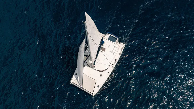 Bellamaggio Yacht Photos Pics Aerial view of 2008 Fountaine Pajot Salina 48 Evolution sailing on deep blue ocean.