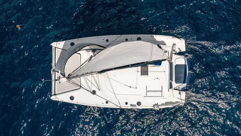 Bellamaggio Yacht Photos Pics Aerial view of 2008 Fountaine Pajot Salina 48 Evolution catamaran sailing on blue ocean.