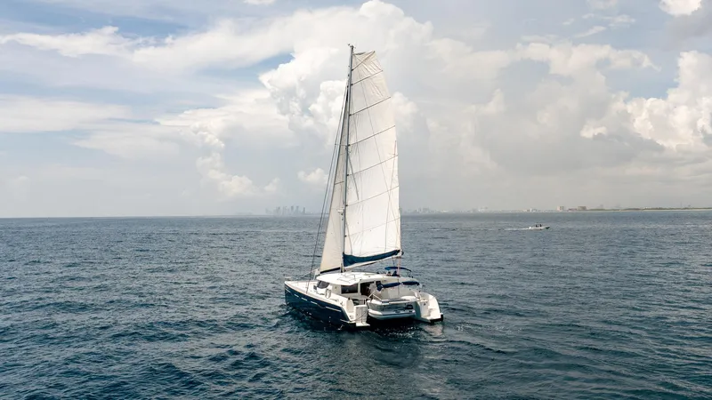 Bellamaggio Yacht Photos Pics Sailing catamaran Fountaine Pajot Salina 48 Evolution, 2008, on open sea under cloudy sky.