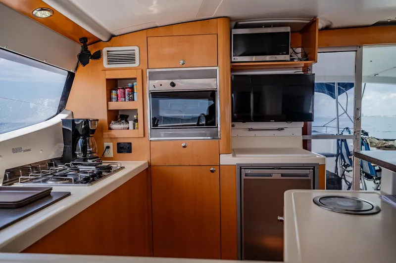 Bellamaggio Yacht Photos Pics Interior of 2008 Fountaine Pajot Salina 48 Evolution yacht kitchen with appliances and ocean view.