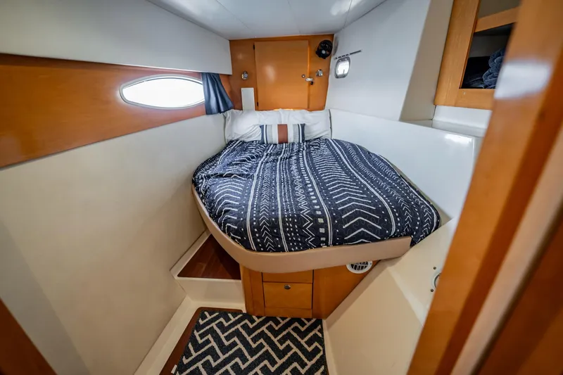 Bellamaggio Yacht Photos Pics Cabin interior of 2008 Fountaine Pajot Salina 48 Evolution with cozy bed and nautical decor.