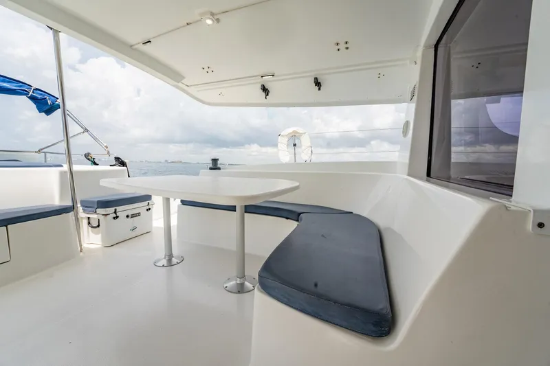 Bellamaggio Yacht Photos Pics 2008 Fountaine Pajot Salina 48 Evolution yacht with outdoor seating and table, ocean view.