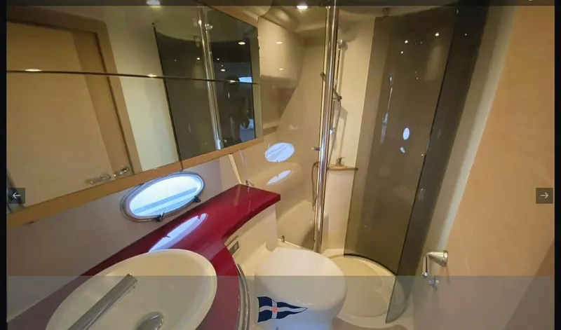  Yacht Photos Pics Luxurious bathroom in 2008 Sessa Marine C42 HT yacht with modern fixtures and porthole window.