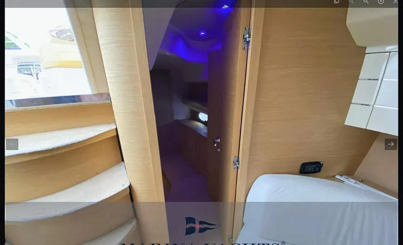  Yacht Photos Pics Interior view of 2008 Sessa Marine C42 HT yacht, featuring wooden stairs and ambient lighting.
