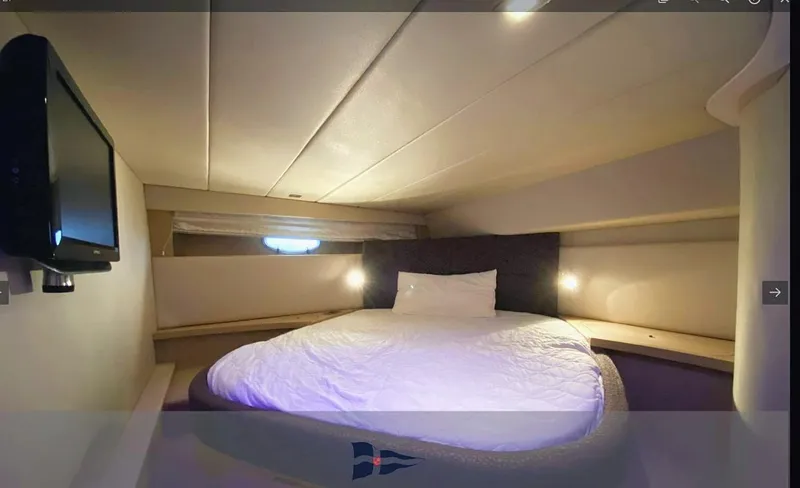  Yacht Photos Pics Luxurious cabin interior of 2008 Sessa Marine C42 HT yacht with cozy bed and ambient lighting.