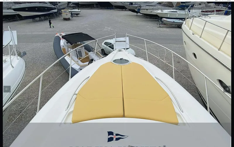  Yacht Photos Pics 2008 Sessa Marine C42 HT yacht with yellow sun pads, docked among other boats.