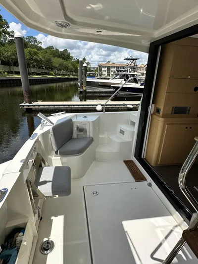 Oceans Edge Yacht Photos Pics 2022 Beneteau Swift Trawler 35, spacious deck with seating, docked at marina.