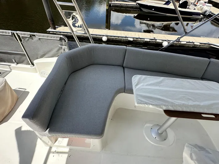 Oceans Edge Yacht Photos Pics Cozy seating area on 2022 Beneteau Swift Trawler 35, docked by the water.