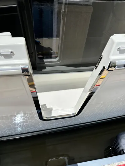 Oceans Edge Yacht Photos Pics 2022 Beneteau Swift Trawler 35, open side gate, reflecting water.