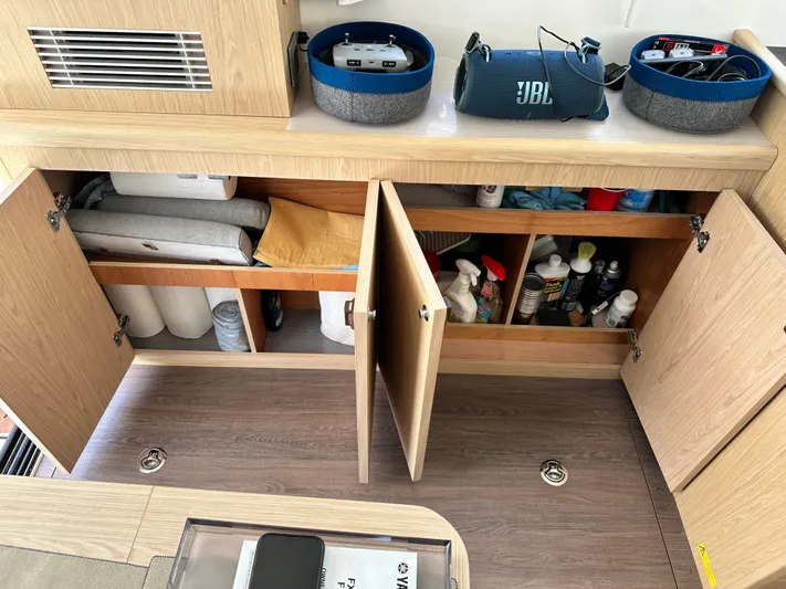Oceans Edge Yacht Photos Pics Interior storage of 2022 Beneteau Swift Trawler 35 with cleaning supplies and JBL speaker.