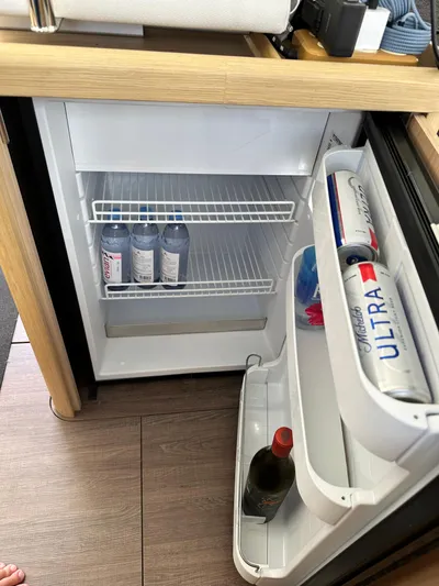 Oceans Edge Yacht Photos Pics Mini fridge inside 2022 Beneteau Swift Trawler 35, stocked with drinks.