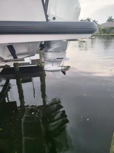  Yacht Photos Pics 2024 Axopar 37 XC CROSS CABIN motorboat stern in calm water.