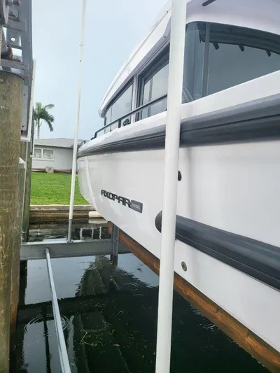  Yacht Photos Pics 2024 Axopar 37 XC CROSS CABIN boat docked, side view.