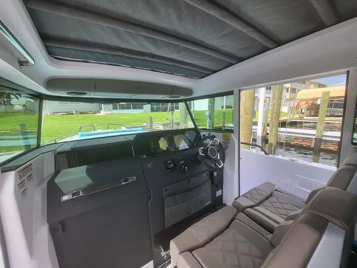  Yacht Photos Pics Interior of 2024 Axopar 37 XC CROSS CABIN, featuring modern helm and seating.