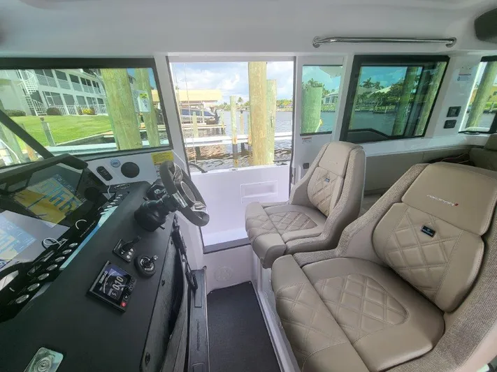  Yacht Photos Pics Interior of 2024 Axopar 37 XC CROSS CABIN with modern dashboard and comfortable seating.