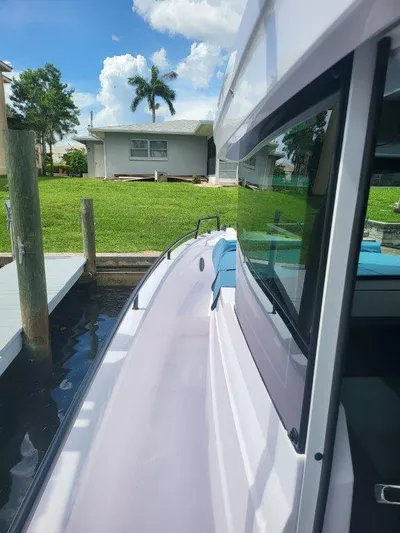  Yacht Photos Pics 2024 Axopar 37 XC CROSS CABIN docked, showcasing sleek design and modern features.