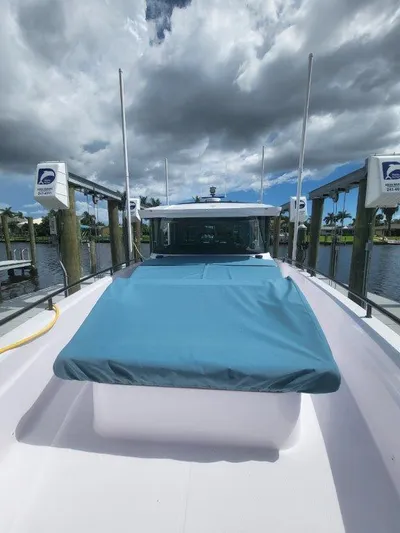  Yacht Photos Pics 2024 Axopar 37 XC CROSS CABIN docked under cloudy skies.